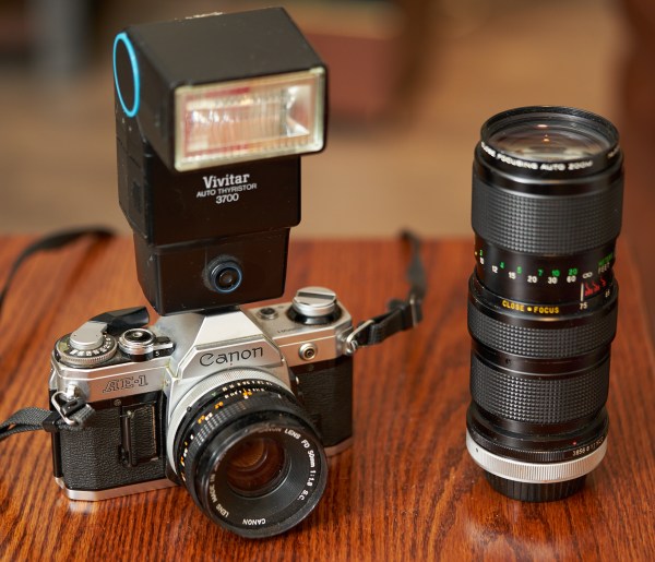 Canon AE-1 with Vivitar flash and 70-210mm Vivitar Zoom lens.